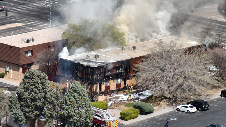 Firefighters at the scene an apartment complex fire